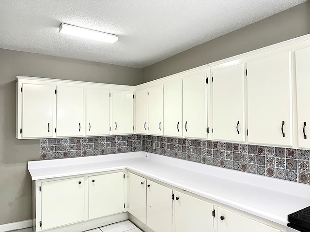 115 Westmont Dr, Dothan, AL 36301 - kitchen featuring tasteful backsplash, light countertops, a textured ceiling, and white cabinets