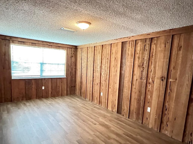 115 Westmont Dr, Dothan, AL 36301 - unfurnished room featuring wood finished floors, a textured ceiling, and wood walls