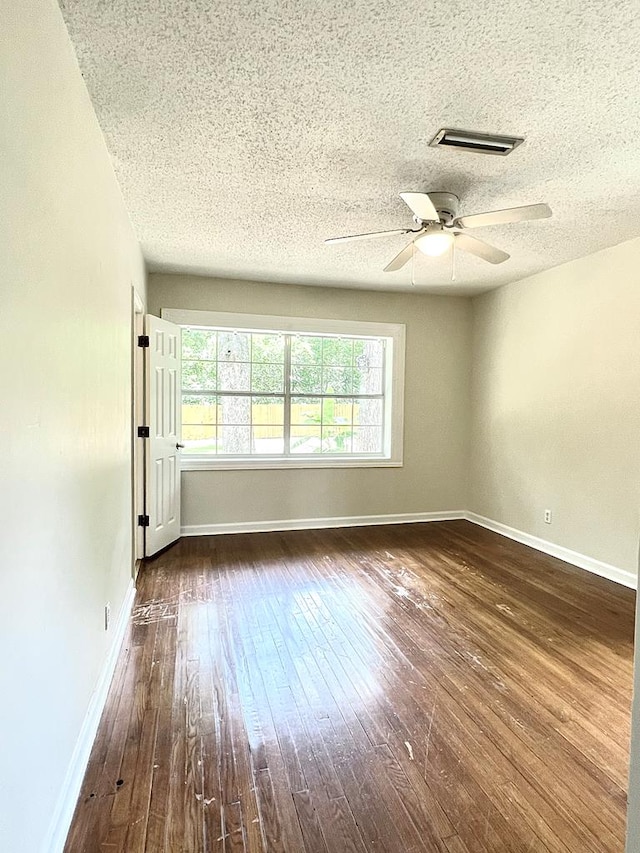 115 Westmont Dr, Dothan, AL 36301 - unfurnished room featuring a ceiling fan, dark wood-style flooring, and a textured ceiling