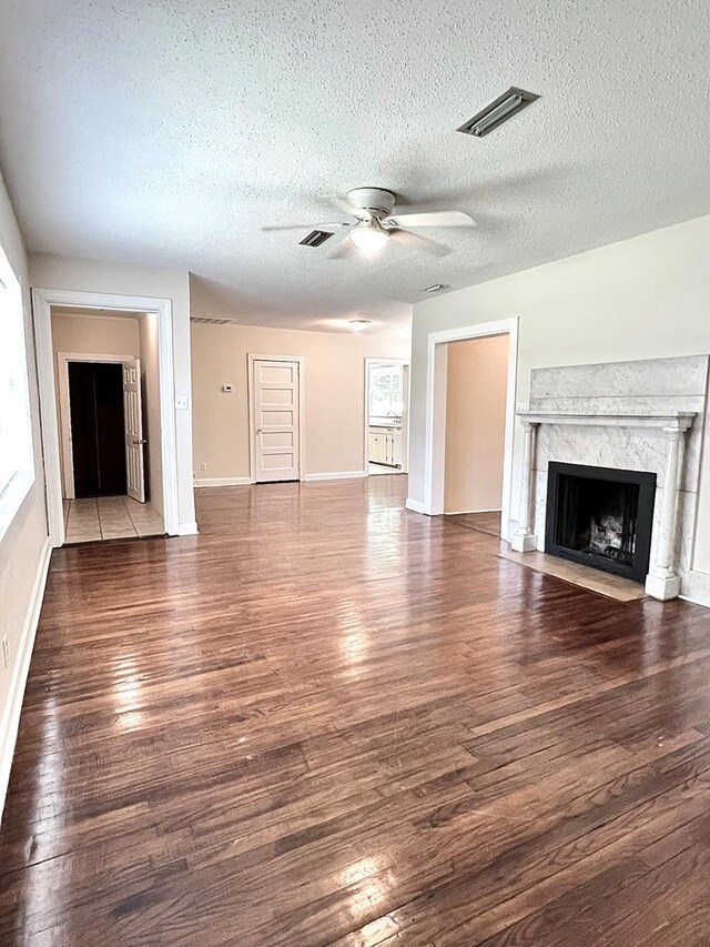 115 Westmont Dr, Dothan, AL 36301 - unfurnished living room with a ceiling fan, a premium fireplace, wood finished floors, and a textured ceiling