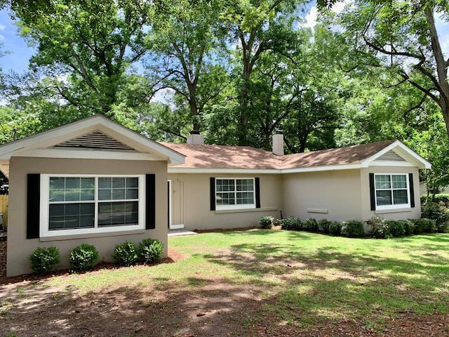 115 Westmont Dr, Dothan, AL 36301 - ranch-style home with a front yard, a chimney, and stucco siding