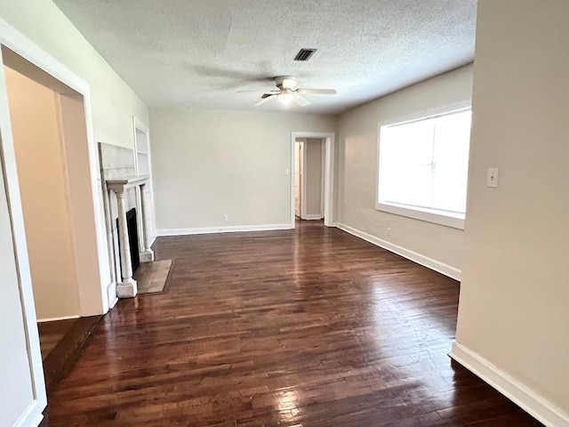 115 Westmont Dr, Dothan, AL 36301 - unfurnished living room featuring a fireplace with flush hearth, a textured ceiling, a ceiling fan, and dark wood finished floors