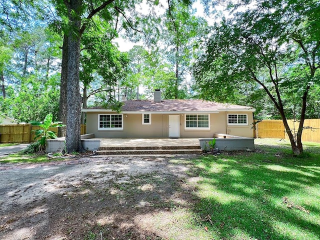 115 Westmont Dr, Dothan, AL 36301 - rear view of property featuring a chimney and stucco siding