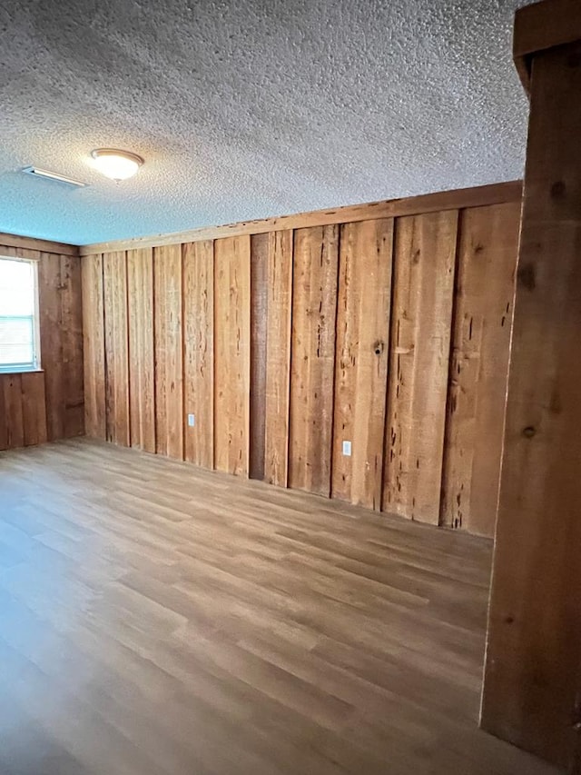 115 Westmont Dr, Dothan, AL 36301 - interior space featuring a textured ceiling, wood finished floors, and wood walls