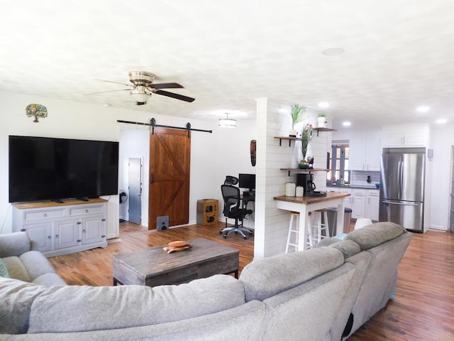 207 Seeba Dr, Dothan, AL 36303 - living room with a barn door, light wood finished floors, ceiling fan, recessed lighting, and an office area