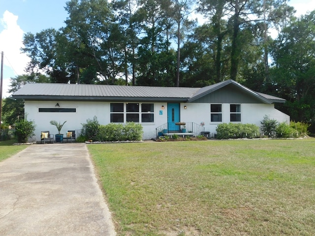 207 Seeba Dr, Dothan, AL 36303 - ranch-style house featuring stucco siding, a front lawn, and a metal roof