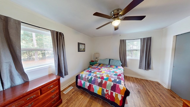 207 Seeba Dr, Dothan, AL 36303 - bedroom featuring multiple windows, light wood finished floors, ceiling fan, and crown molding