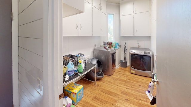 207 Seeba Dr, Dothan, AL 36303 - laundry room featuring cabinet space, light wood-type flooring, and washing machine and clothes dryer