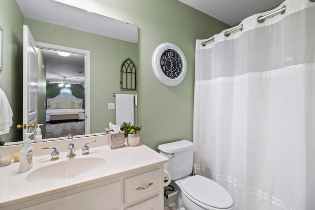 bathroom featuring toilet, connected bathroom, and vanity