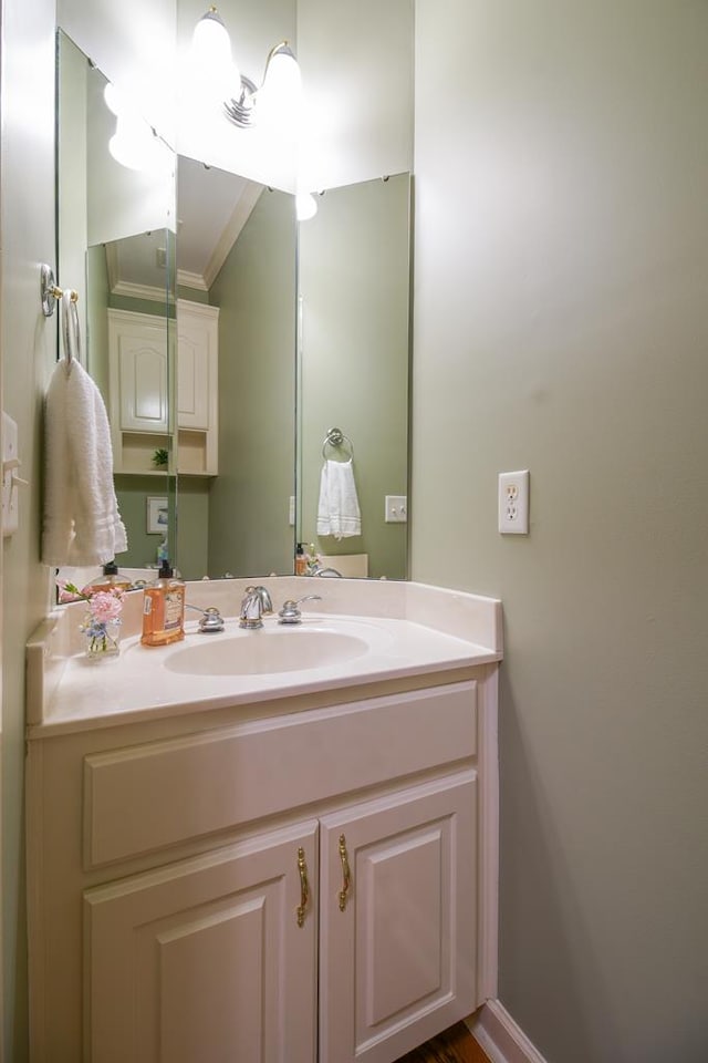 bathroom featuring ornamental molding and vanity