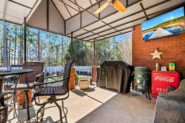 view of patio / terrace with ceiling fan, fence, grilling area, and outdoor dining space