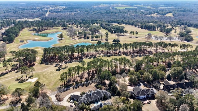 drone / aerial view with a water view and golf course view