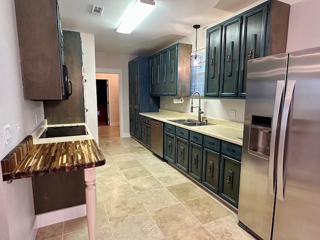 426 Walker Rd, Ozark, AL 36360 - kitchen featuring appliances with stainless steel finishes, light countertops, and decorative light fixtures