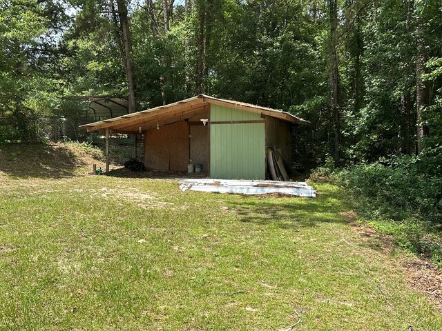 426 Walker Rd, Ozark, AL 36360 - view of outbuilding with a wooded view
