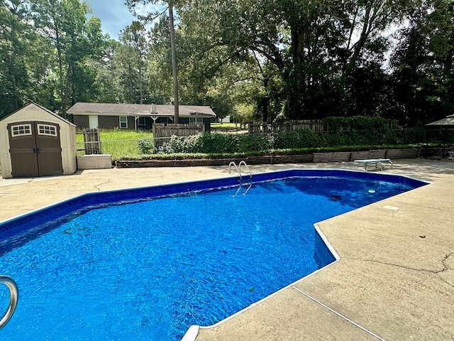 426 Walker Rd, Ozark, AL 36360 - view of swimming pool with a storage unit, a patio, a diving board, and view of scattered trees