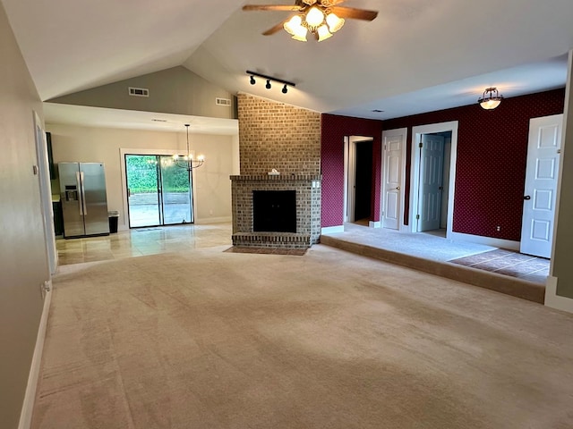 426 Walker Rd, Ozark, AL 36360 - unfurnished living room with a ceiling fan, light colored carpet, vaulted ceiling, a fireplace, and a chandelier