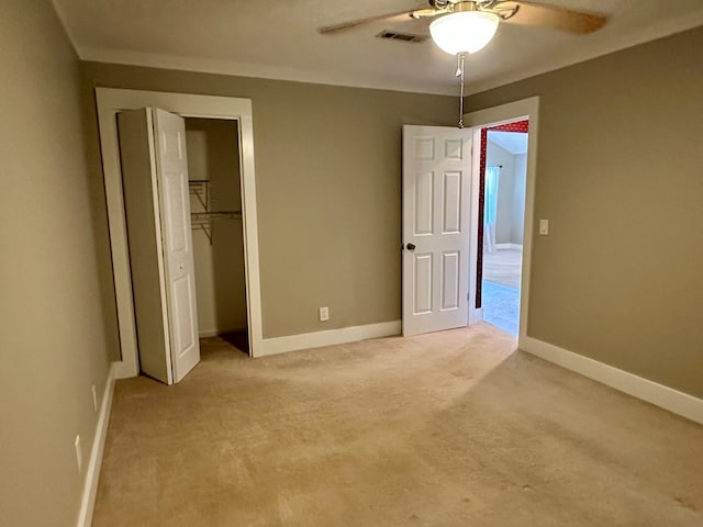 426 Walker Rd, Ozark, AL 36360 - unfurnished bedroom featuring light colored carpet, a closet, and a ceiling fan