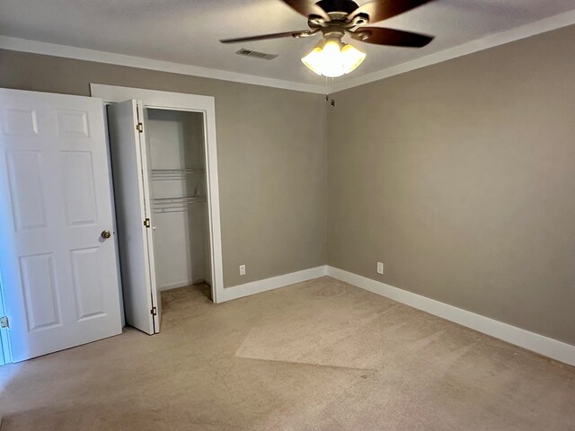 426 Walker Rd, Ozark, AL 36360 - unfurnished bedroom featuring light colored carpet, a closet, a ceiling fan, and crown molding