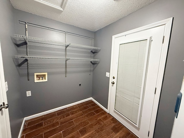 40 Caravan Ln, Kinsey, AL 36303 - laundry room with electric dryer hookup, hookup for a washing machine, dark wood finished floors, baseboards, and a textured ceiling