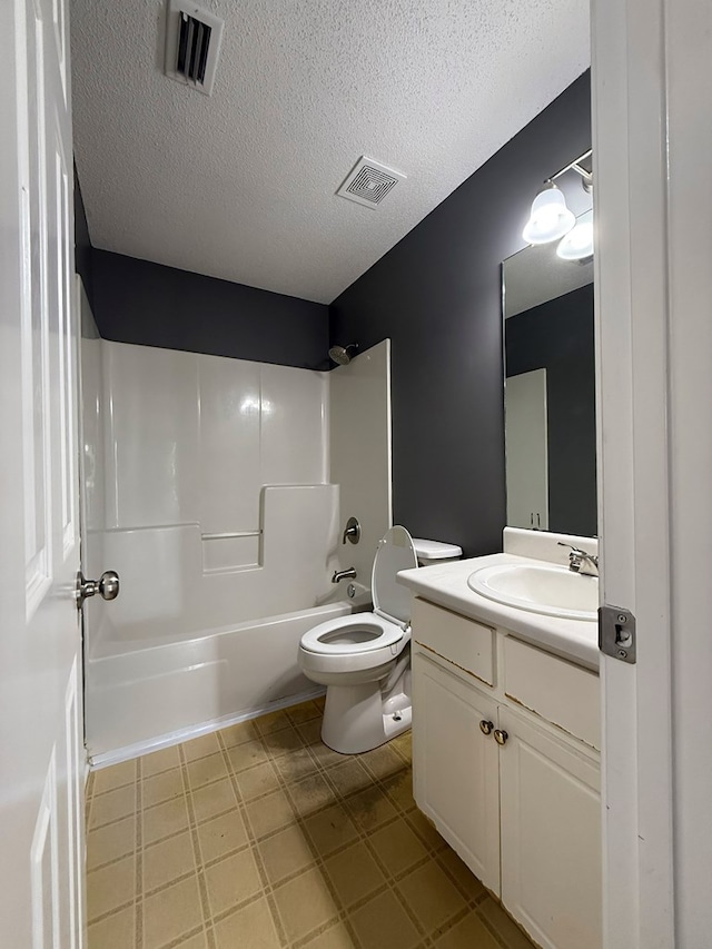 40 Caravan Ln, Kinsey, AL 36303 - bathroom featuring vanity, bathing tub / shower combination, toilet, and a textured ceiling