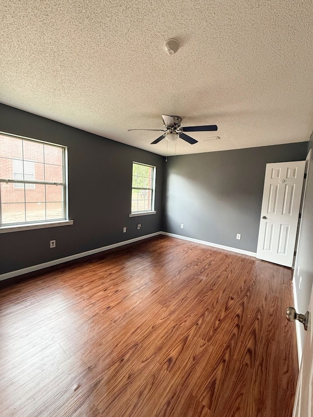 40 Caravan Ln, Kinsey, AL 36303 - unfurnished room featuring a textured ceiling, wood finished floors, ceiling fan, and baseboards