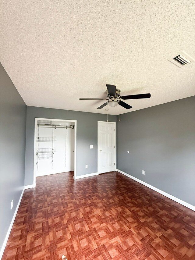 40 Caravan Ln, Kinsey, AL 36303 - unfurnished bedroom with a textured ceiling, baseboards, and a ceiling fan