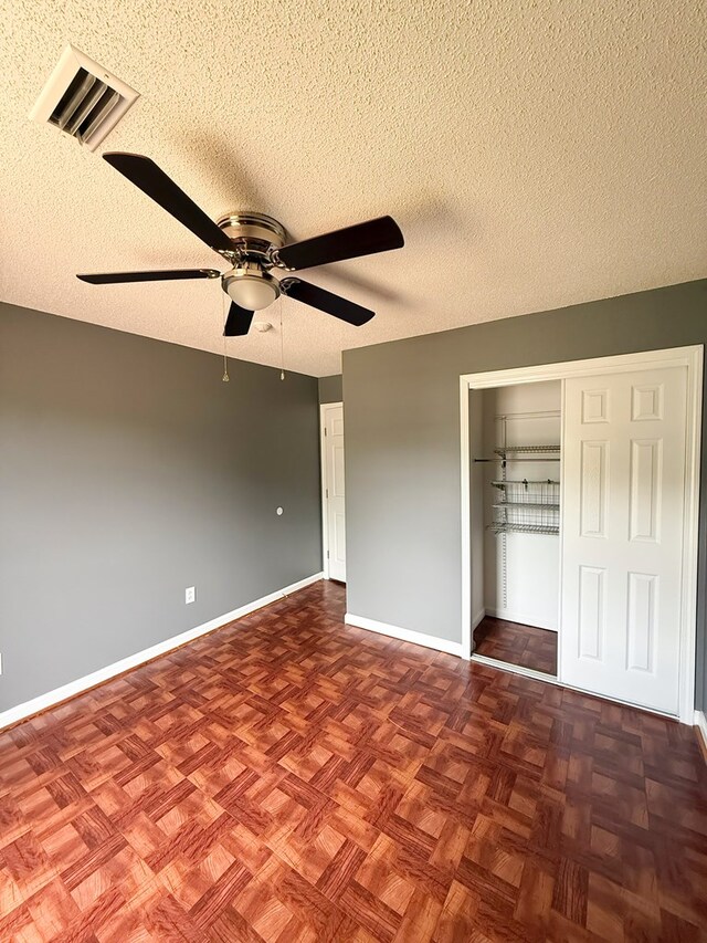 40 Caravan Ln, Kinsey, AL 36303 - unfurnished bedroom with a textured ceiling, baseboards, a closet, and a ceiling fan