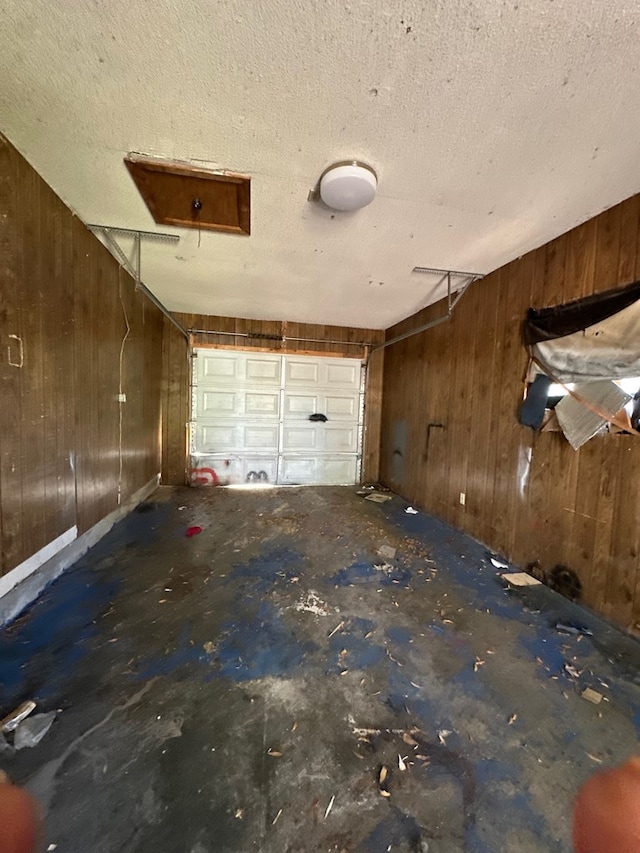 garage featuring wooden walls
