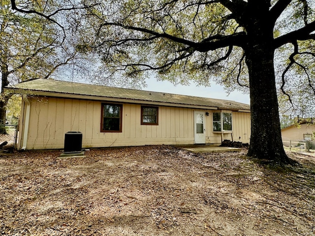 rear view of house featuring metal roof and central air condition unit