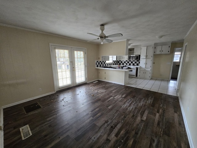 unfurnished living room featuring french doors, ceiling fan, ornamental molding, and dark hardwood / wood-style flooring