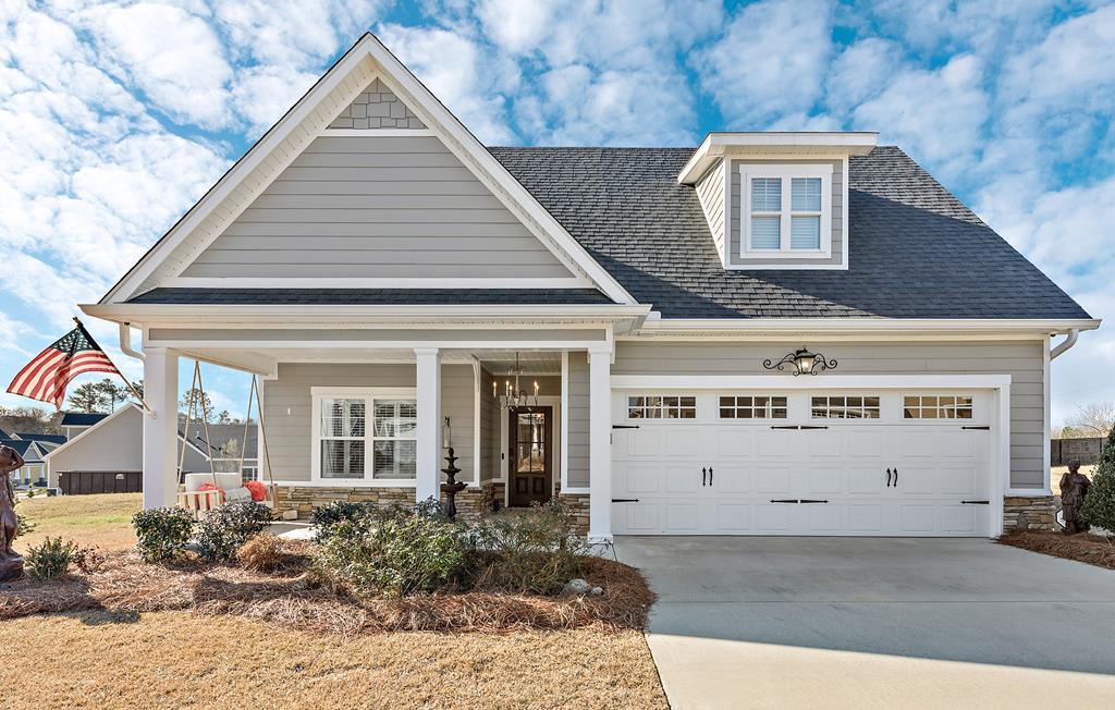 view of front of house with covered porch and a garage