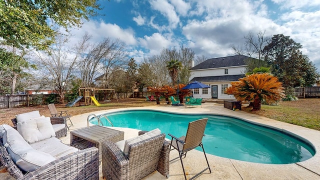 view of pool with a playground, a patio, and an outdoor hangout area