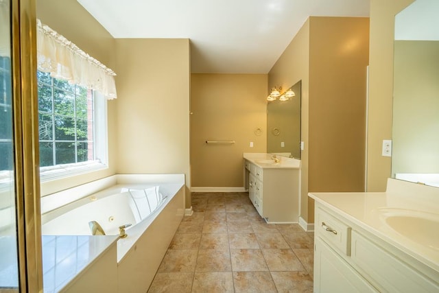 401 Dunleith Blvd, Dothan, AL 36303 - bathroom featuring two vanities, a jetted tub, and baseboards