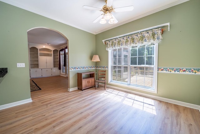 401 Dunleith Blvd, Dothan, AL 36303 - unfurnished room with arched walkways, baseboards, wood finished floors, ornamental molding, and built in shelves