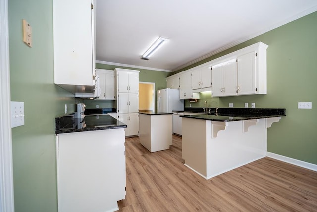401 Dunleith Blvd, Dothan, AL 36303 - kitchen featuring white appliances, a peninsula, white cabinetry, crown molding, and light wood-style floors