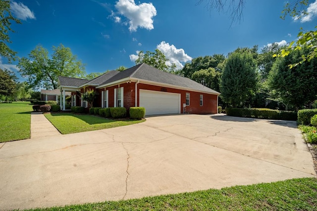 401 Dunleith Blvd, Dothan, AL 36303 - view of side of property featuring brick siding, a lawn, a garage, and driveway