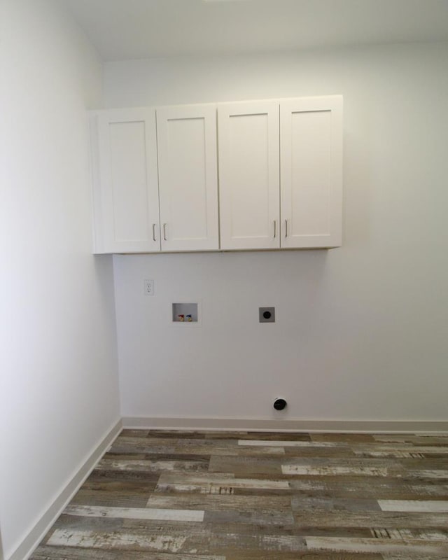 washroom with hookup for an electric dryer, dark hardwood / wood-style flooring, cabinets, and washer hookup