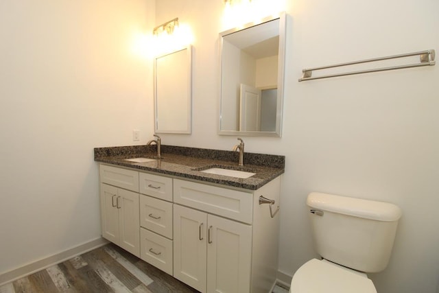 bathroom featuring hardwood / wood-style floors, vanity, and toilet