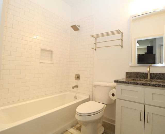 full bathroom with toilet, vanity, and tiled shower / bath