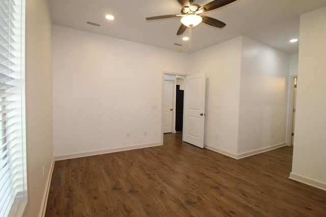 unfurnished room with ceiling fan and dark wood-type flooring