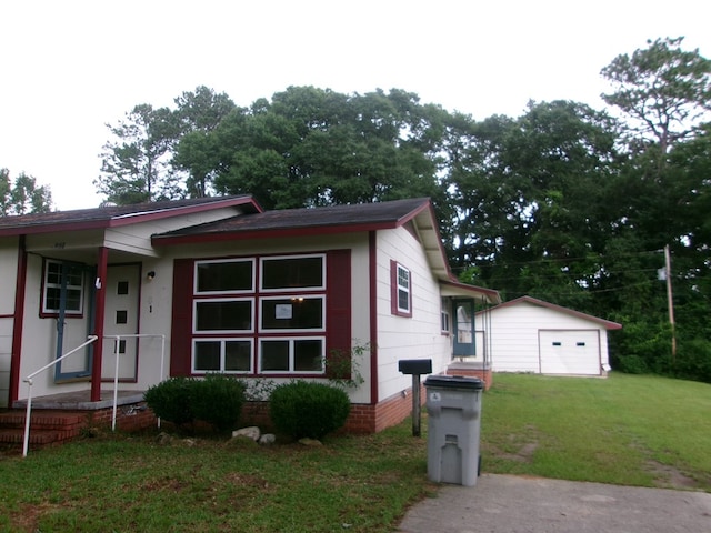934 Sunset Blvd, Elba, AL 36323 - view of front facade with a front lawn, an outbuilding, and a garage