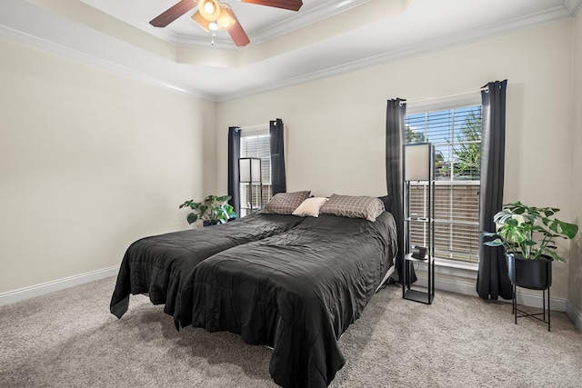 115 Brittany Dr, Dothan, AL 36301 - carpeted bedroom featuring a tray ceiling, multiple windows, ornamental molding, and a ceiling fan