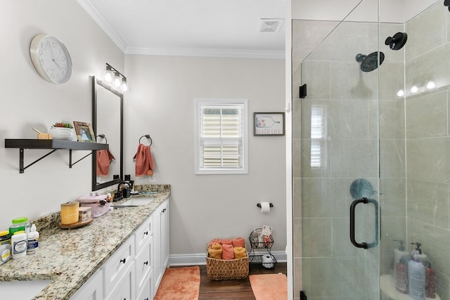 1908 Baxter Rd, Ashford, AL 36312 - bathroom featuring double vanity, ornamental molding, a shower stall, and wood finished floors