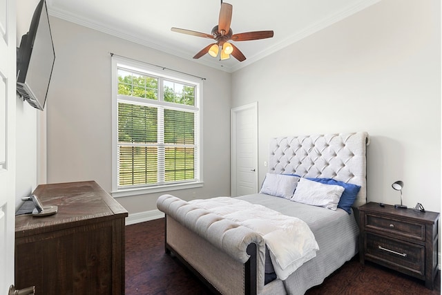 bedroom featuring baseboards, crown molding, dark wood-type flooring, and a ceiling fan