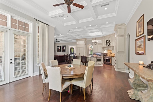 dining space with coffered ceiling, dark wood finished floors, arched walkways, beamed ceiling, and ceiling fan with notable chandelier