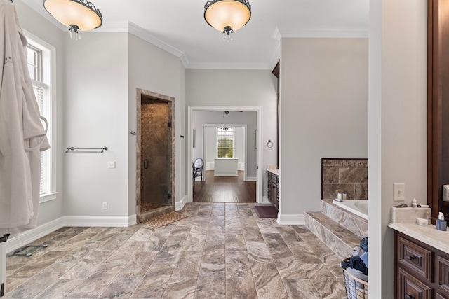 full bath featuring a stall shower, baseboards, a garden tub, and ornamental molding