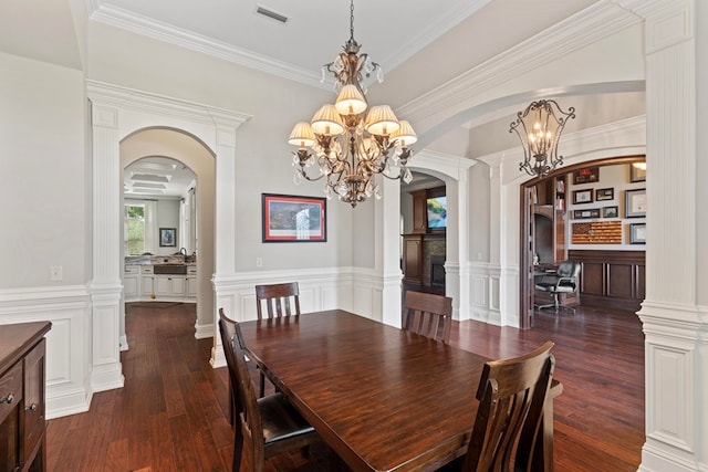 dining room featuring visible vents, arched walkways, a notable chandelier, and dark wood finished floors