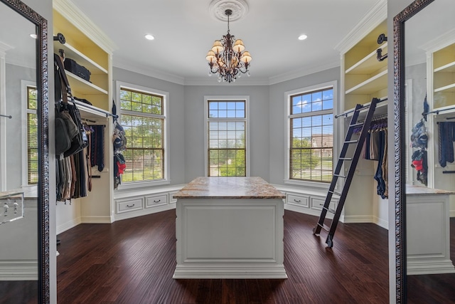 spacious closet featuring dark wood-type flooring and a chandelier