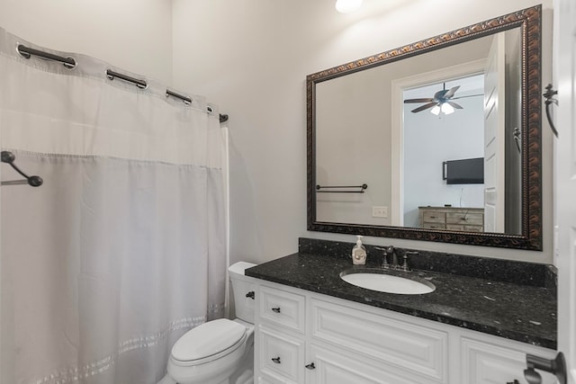 bathroom with vanity, a shower with curtain, toilet, and a ceiling fan