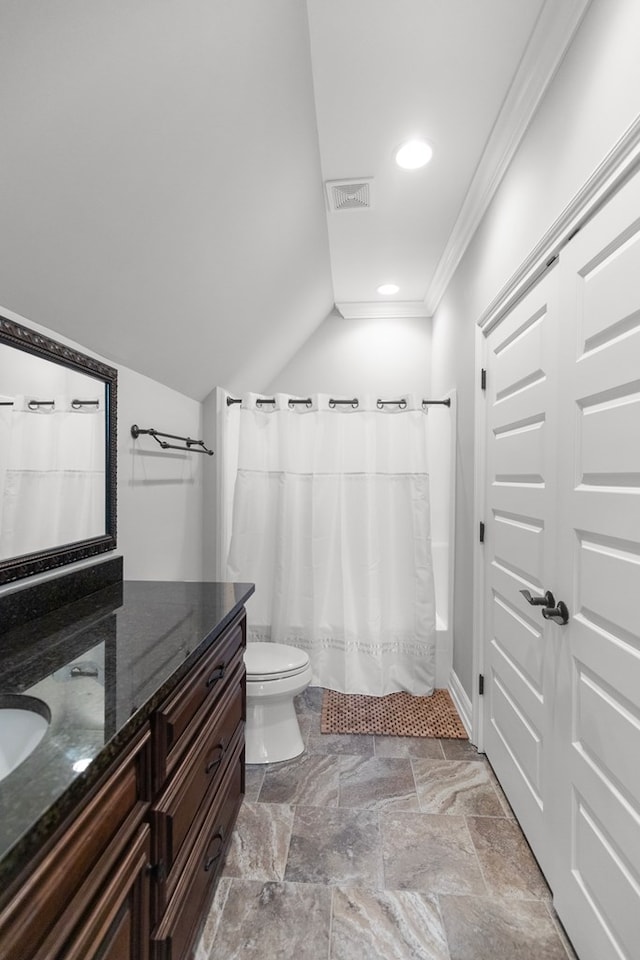 bathroom featuring visible vents, toilet, crown molding, lofted ceiling, and vanity